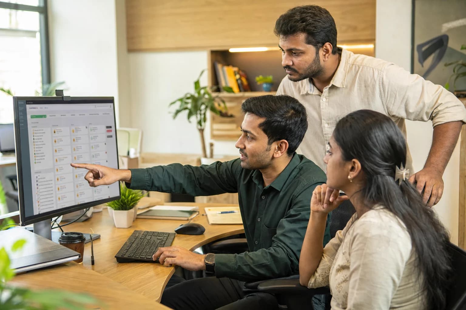 An Indian operations team reviewing a shared workflow system
